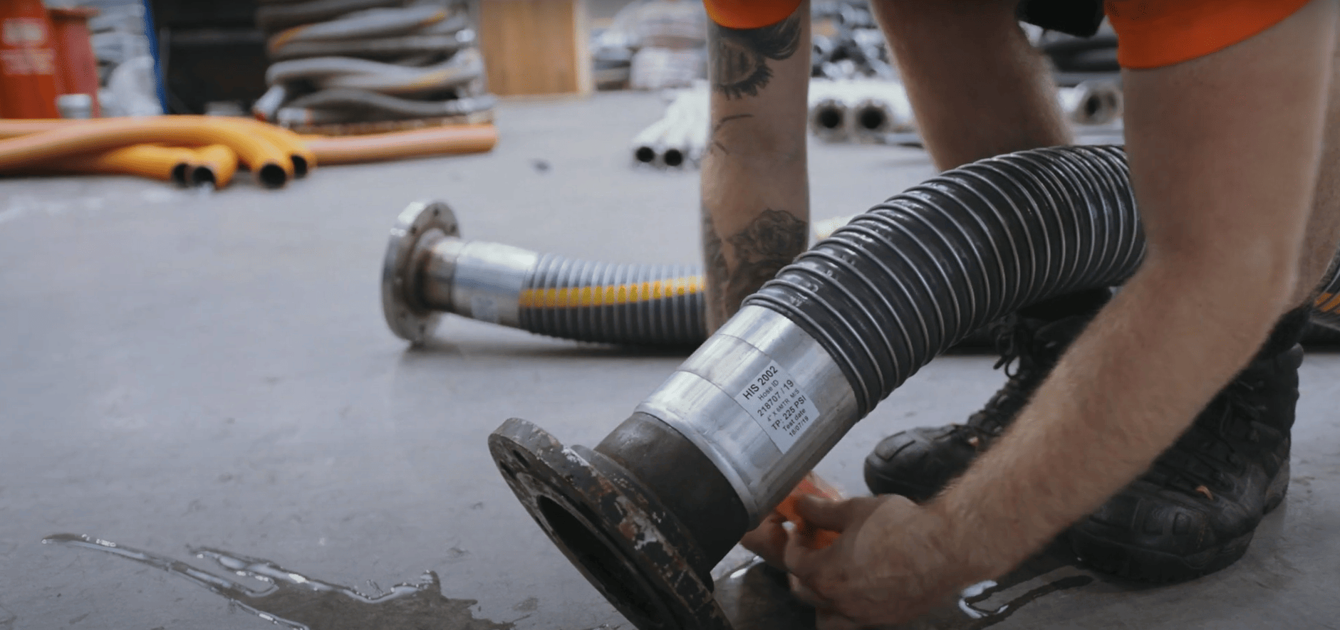 man attaching tag to hydraulic hose