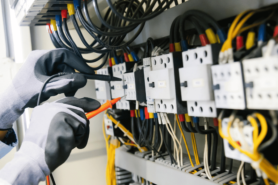 man inspecting electrical wires