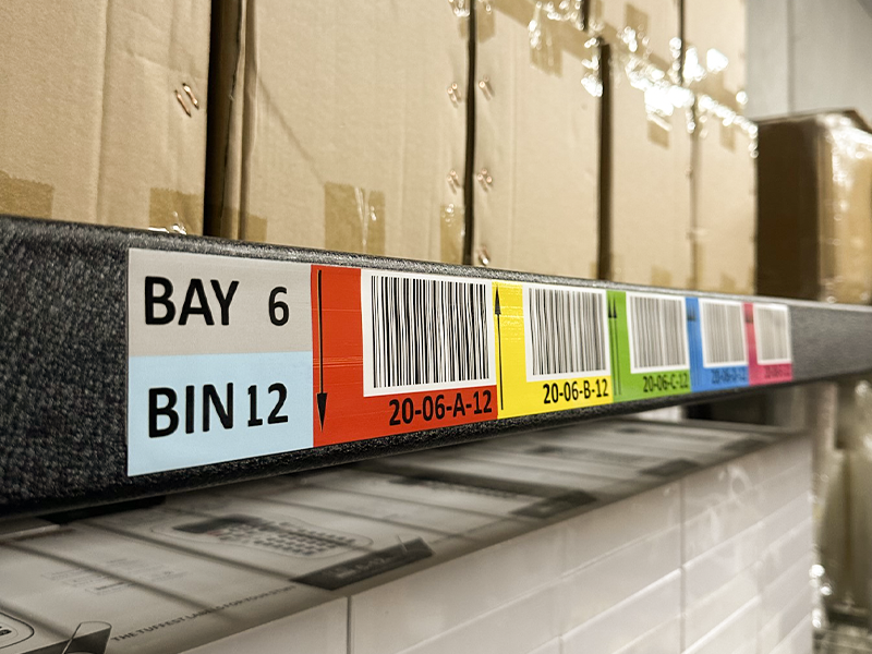 Bin Location Label with barcodes and colours on a shelf